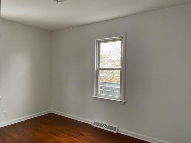 unfurnished room with dark hardwood / wood-style floors