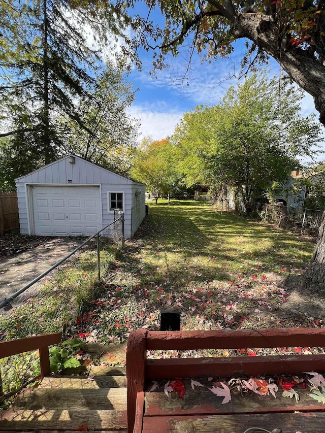 view of yard featuring a garage and an outbuilding