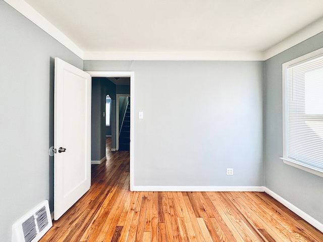 spare room with wood-type flooring