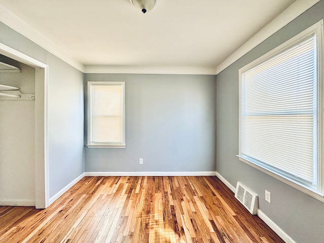 unfurnished bedroom with hardwood / wood-style floors and a closet