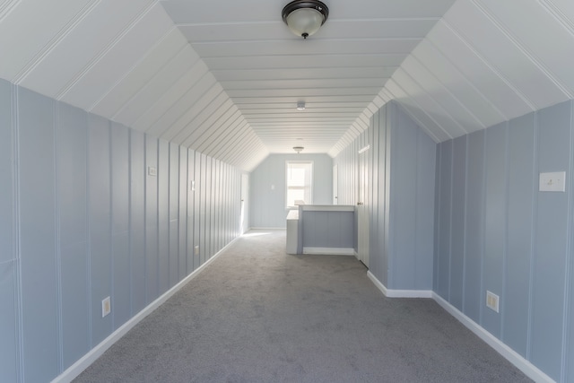 additional living space with lofted ceiling and light carpet