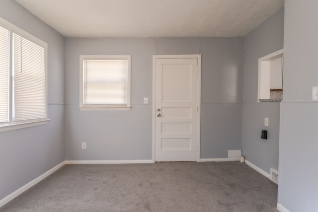 clothes washing area featuring light colored carpet