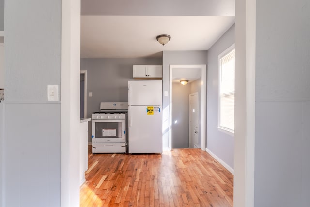 kitchen with white appliances and light wood-type flooring