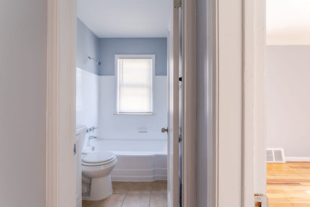 bathroom featuring tile patterned floors and toilet