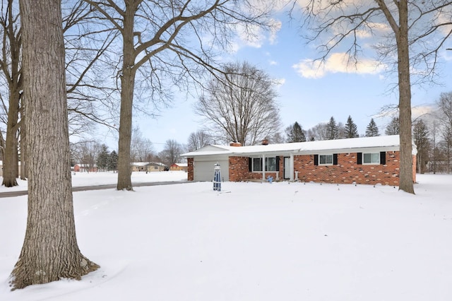 11870 Woodland Dr, Lennon, MI 48449 - view of front of home with brick siding and a chimney