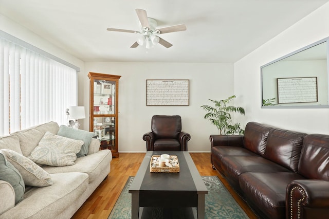 11870 Woodland Dr, Lennon, MI 48449 - living area with a ceiling fan, light wood-style flooring, and baseboards