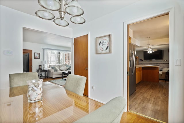 11870 Woodland Dr, Lennon, MI 48449 - dining room with a chandelier, light wood-type flooring, and a ceiling fan