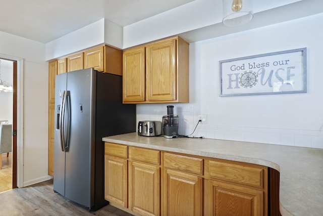 11870 Woodland Dr, Lennon, MI 48449 - kitchen featuring stainless steel fridge, light countertops, light wood-style floors, and backsplash
