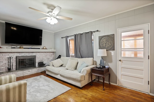 11870 Woodland Dr, Lennon, MI 48449 - living room with crown molding, ceiling fan, a brick fireplace, and wood finished floors
