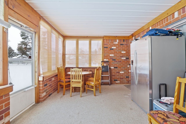 11870 Woodland Dr, Lennon, MI 48449 - dining space featuring light colored carpet and brick wall