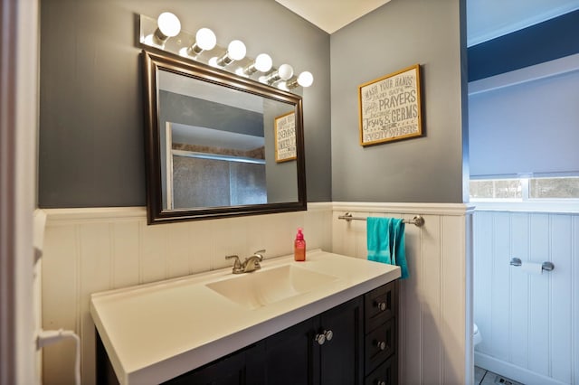 11870 Woodland Dr, Lennon, MI 48449 - bathroom with a decorative wall, a wainscoted wall, vanity, and toilet