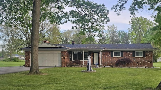 11870 Woodland Dr, Lennon, MI 48449 - ranch-style house with a garage, driveway, a front yard, and brick siding