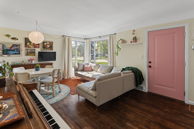 living room featuring visible vents and dark wood-type flooring