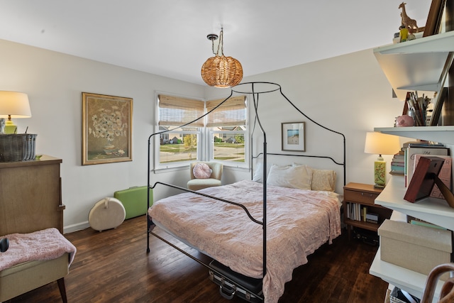 bedroom featuring dark wood-style floors and baseboards