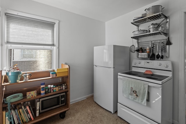 kitchen with white appliances and baseboards