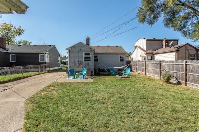 back of house featuring a yard, a patio area, and a fenced backyard