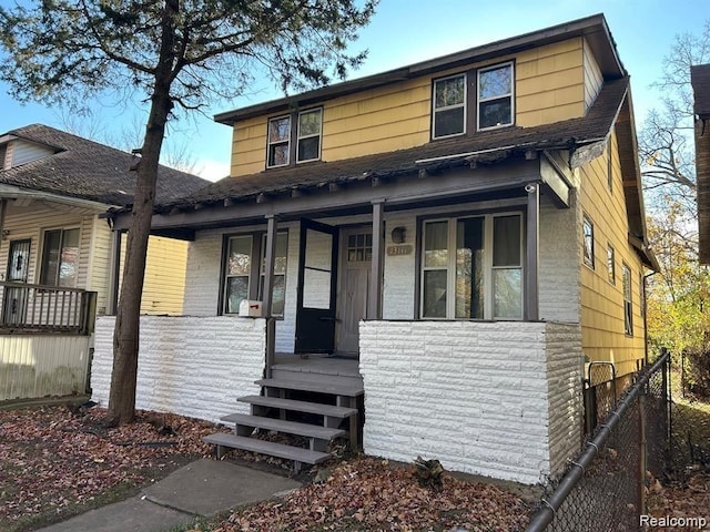 bungalow-style house with covered porch and fence