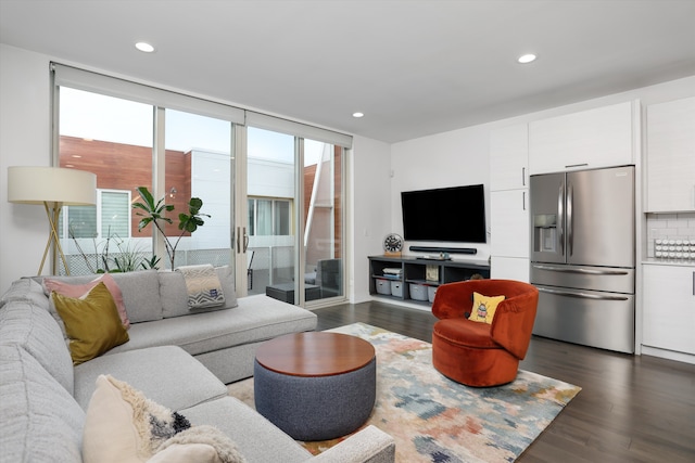 living room with floor to ceiling windows and dark wood-type flooring