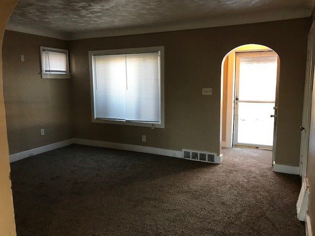 spare room with carpet floors and a textured ceiling