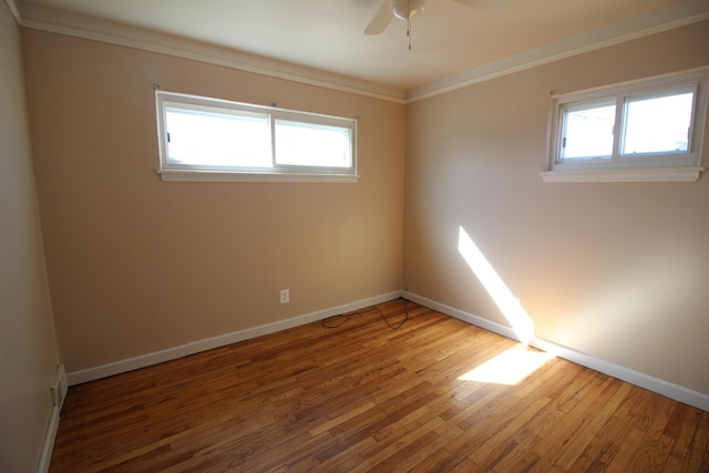 26132 Hanover St, Dearborn Heights, MI 48125 - spare room with crown molding, a wealth of natural light, and wood-type flooring