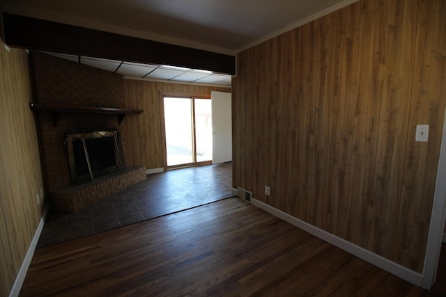 26132 Hanover St, Dearborn Heights, MI 48125 - unfurnished living room featuring a brick fireplace, dark wood-type flooring, and wooden walls