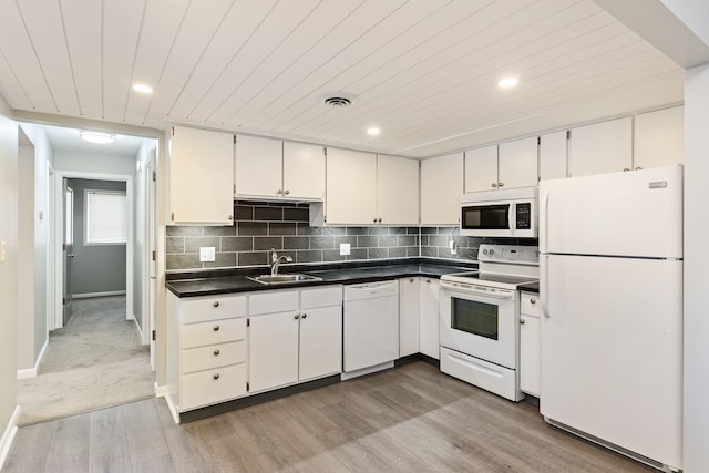 kitchen with sink, white appliances, white cabinetry, backsplash, and wooden ceiling