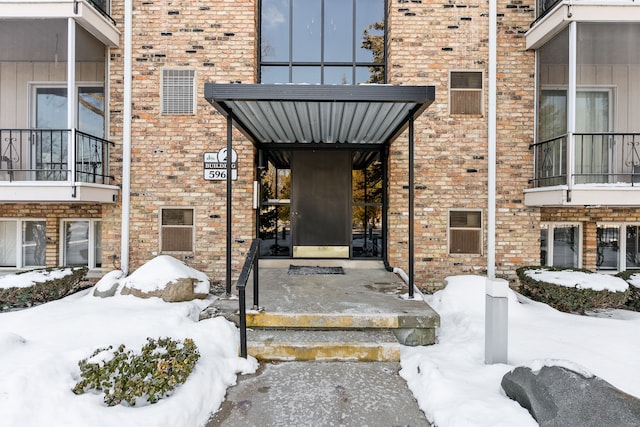 view of snow covered property entrance