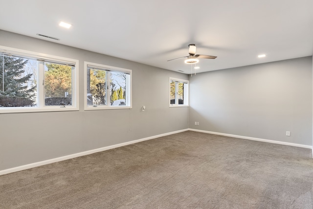 carpeted spare room featuring ceiling fan