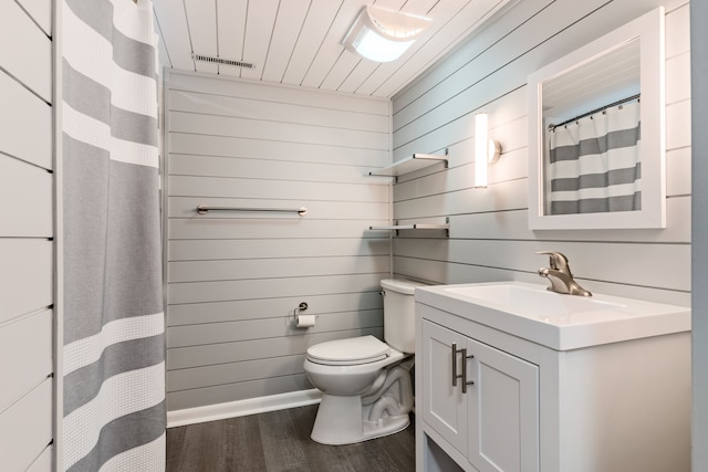 bathroom with vanity, wood-type flooring, and toilet