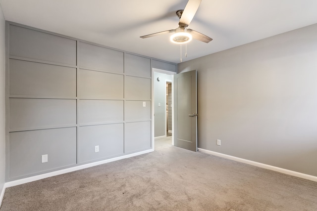 unfurnished bedroom featuring ceiling fan and light carpet