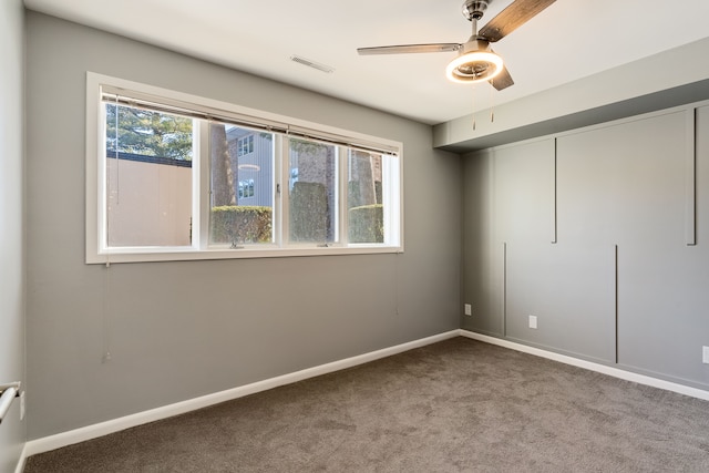 carpeted empty room with ceiling fan