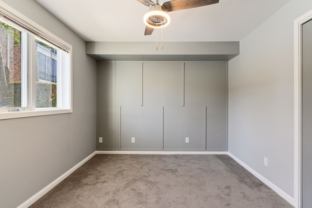 unfurnished bedroom featuring light colored carpet and ceiling fan