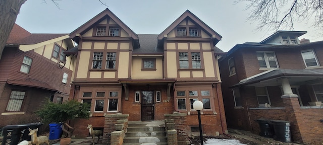 tudor home with brick siding and stucco siding