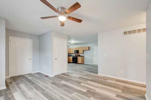 unfurnished living room featuring ceiling fan and light hardwood / wood-style flooring