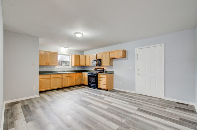 kitchen featuring light brown cabinetry, sink, black appliances, and light hardwood / wood-style floors