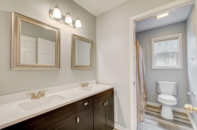 bathroom featuring vanity, hardwood / wood-style flooring, a shower with curtain, and toilet