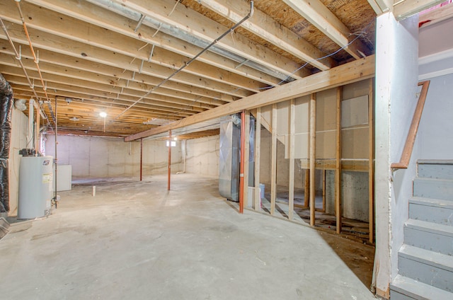 basement featuring washer / clothes dryer, heating unit, and gas water heater