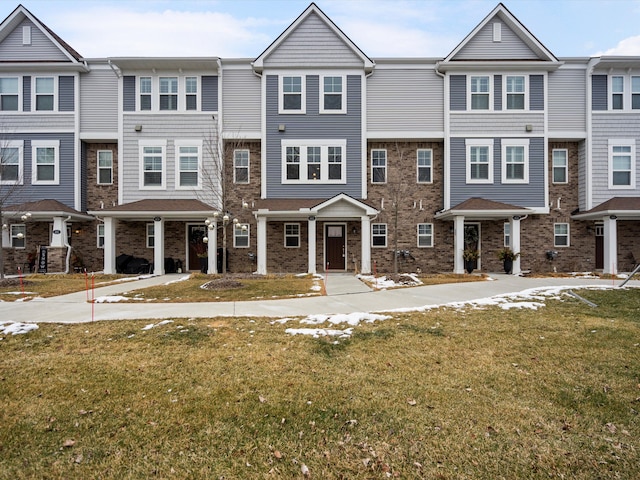 view of property featuring a front lawn