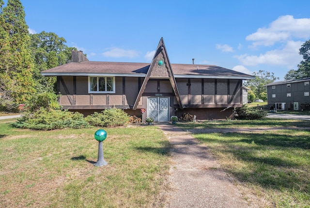 view of front of house with a sunroom and a front lawn