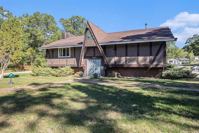 view of front of home with a sunroom and a front lawn