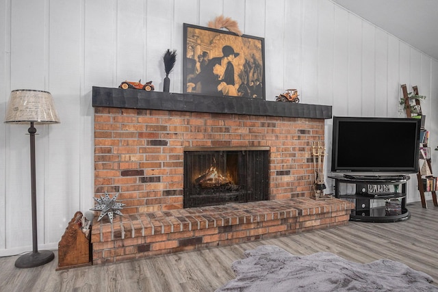 living room with a fireplace and wood-type flooring