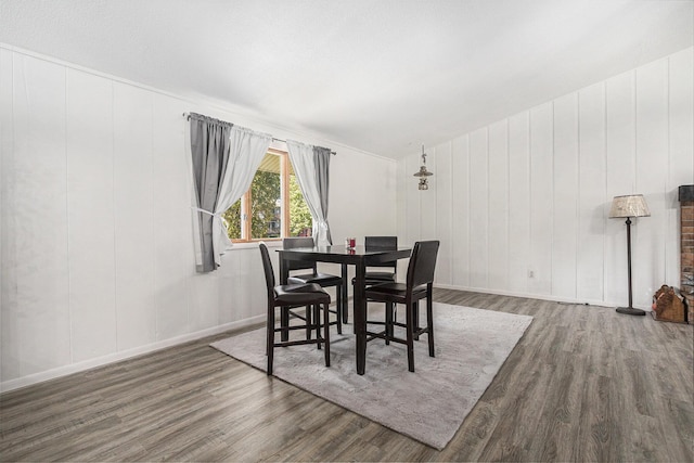 dining space with dark hardwood / wood-style flooring