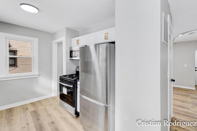 kitchen featuring light hardwood / wood-style flooring, stainless steel appliances, and white cabinets