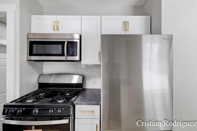 kitchen featuring tasteful backsplash, stainless steel appliances, and white cabinets