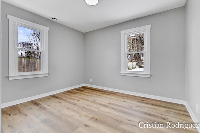 empty room with light hardwood / wood-style floors