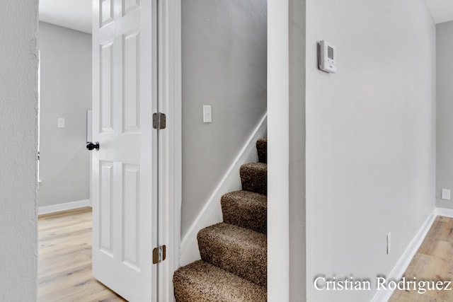 stairs featuring hardwood / wood-style floors