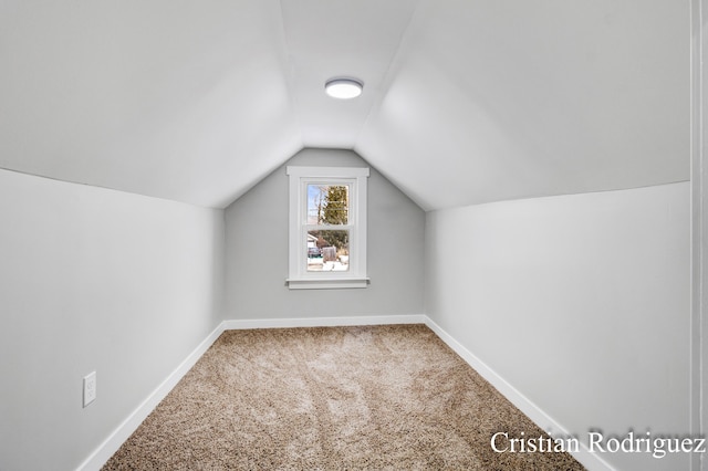 bonus room with carpet floors and vaulted ceiling