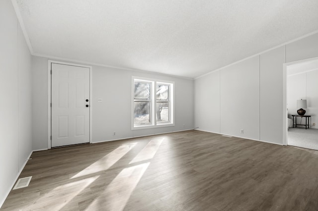 unfurnished room featuring ornamental molding, light hardwood / wood-style flooring, and a textured ceiling