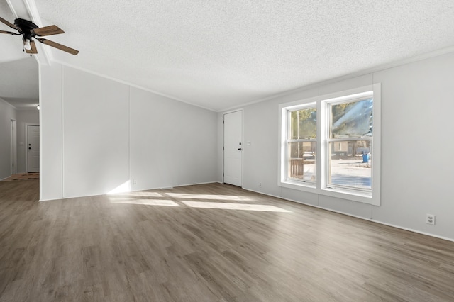 spare room featuring hardwood / wood-style flooring, ceiling fan, and a textured ceiling