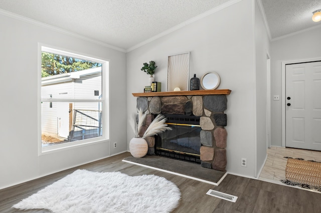 living room featuring lofted ceiling, crown molding, a fireplace, wood-type flooring, and a textured ceiling